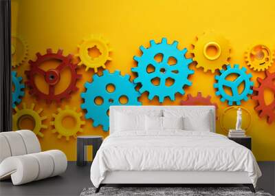 Various vibrant mechanical gears aligned on a flat yellow surface, symbolizing business agility and modern management practices Wall mural