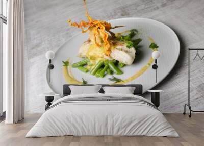 White fish baked with beans on a white plate Wall mural