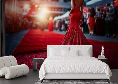 Rear view of a woman in gorgeous evening dress standing on a red carpet Wall mural