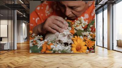 Senior woman celebrating day of the dead with decorated skull and cempasuchil flowers Wall mural