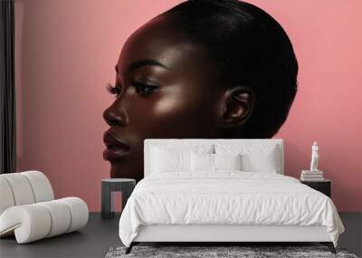 Side profile of a black woman model showcasing minimalist beauty on pink. Wall mural