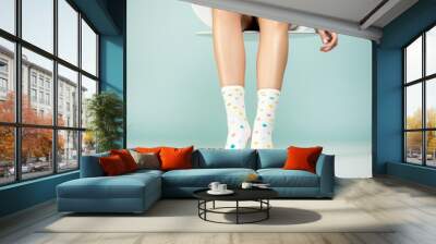 Pair of socks on bare feet. Wall mural