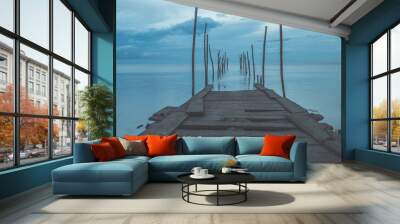 Footbridge sea beach for journey calm hormone. Wooden pier or jetty remains on a blue ocean Wall mural