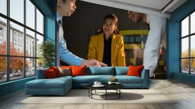 Business Team Collaborating in Office Meeting with Focus on Woman in Yellow Blazer Wall mural