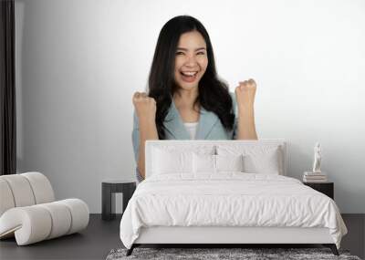 Excited young asian woman with raised hand celebrating success Portrait cheerful positive asian female with raised hands and fists open mouth Girl get happy enjoy life white background copy space. Wall mural