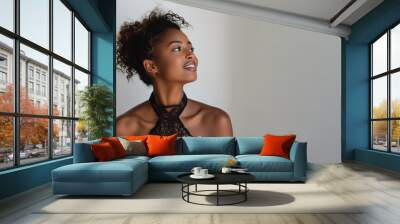 Afro elegant woman in black halterneck dress isolate on gray Wall mural