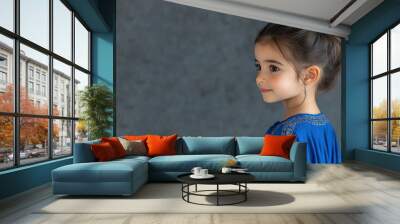 Arabian little girl wearing moroccan kaftan isolated on gray Wall mural