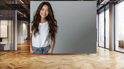 Asian woman wear white t-shirt smile isolated on grey background Wall mural