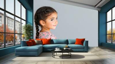 Australian little girl wearing moroccan kaftan isolated on grey Wall mural