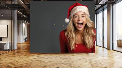 Blonde girl surprise face in santa claus red hat, Christmas sale gift Wall mural