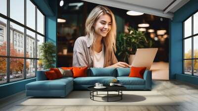 Blonde long hair student girl smile using notebook laptop, woman  study online hybrid learning in coworking third space Wall mural