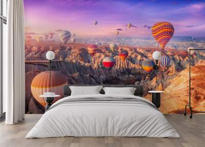 Aerial view amazing sunrise landscape in Cappadocia with colorful hot air balloon fly in sky over deep canyons, valleys. Concept banner travel Turkey Wall mural