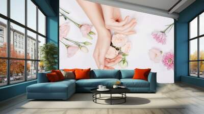 Beautiful stylish trendy female pink manicure with flower on background, top view. Concept bio nature cosmetics skin care Wall mural