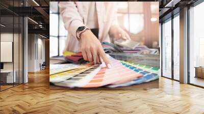 Closeup hand of woman decorator, interior and graphic designer, architect is choosing catalogue colors ral for web project Wall mural