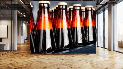 Glass bottles of beer on dark background. Concept brewery plant production line Wall mural