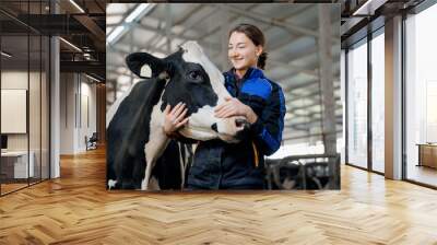 happy young woman farm worker hugging cow as sign of concern for animal health care. concept agricul Wall mural