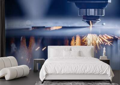 Laser CNC cutting of metal with light spark, modern industrial technology. Blue color steel tool Wall mural