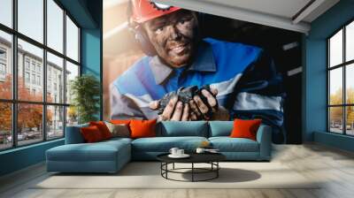 Miner happy man smiling after working on coal mine. Concept industrial engineer Wall mural