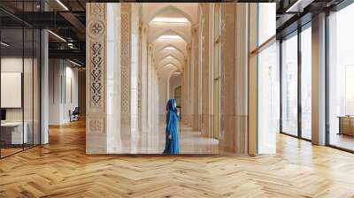 Modern woman in traditional blue abaya standing in Grand Mosque. Concept traveling by Astana Kazakhstan Wall mural