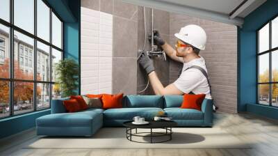 Plumber installing water taps shower stall, work in bathroom Wall mural