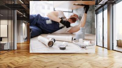 Plumber man at work in bathroom, fix repair service. Concept assemble and install plumbing Wall mural