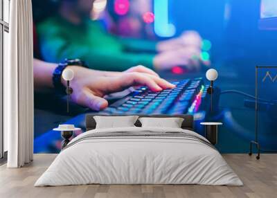 Professional cyber video gamer studio room with personal computer armchair, keyboard for stream in neon color blur background. Soft focus Wall mural