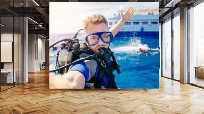 Selfie photo man diver scuba diving blue water sea looking at camera with sun light. Concept travel extreme sport Wall mural