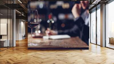 Sommeliers male tasting red wine and making notes aroma degustation card Wall mural