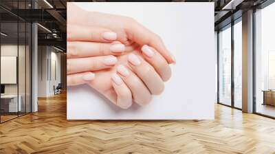 Stylish trendy nail young woman hands pink manicure on white background Wall mural