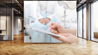 Young woman patient at gynecologist appointment consults in medical institution Wall mural