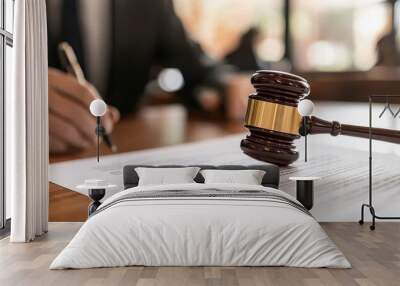 A gavel placed on a legal document, symbolizing justice and law in a courtroom setting. Wall mural