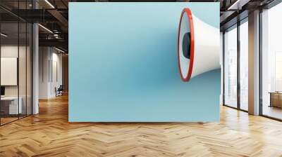 A vibrant megaphone against a soft blue background, perfect for themes of communication, announcements, and public speaking. Wall mural