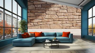 Interior stone wall with shadows, showcasing a warm texture and natural ambiance. Wall mural