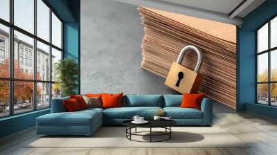 Locked padlock on a stack of brown paper files, security concept. Wall mural