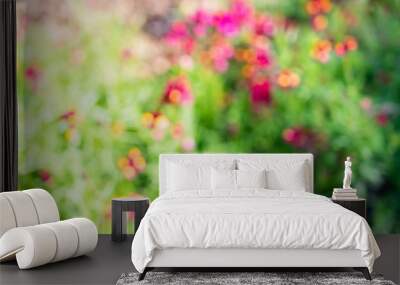 Colorful blur flowers in the garden background. Wall mural