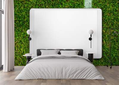 Digital tablet on grass soccer field background. Wall mural