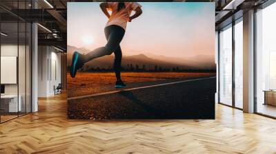 Woman enjoys running outside with beautiful summer evening in the countryside. Wall mural