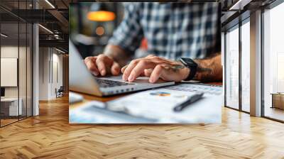 Accountant managing financial records on a laptop, in an office with a minimalist, clean design Wall mural