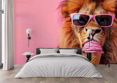 Stylish lion wearing sunglasses eating a pink ice cream cone against a pink background, showcasing a fun and quirky concept. Wall mural