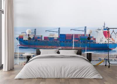 Tugboats assisting container cargo ship to harbor, logistics and transportation of International container cargo ship in the ocean Transportation, ship in import export in europe. Wall mural