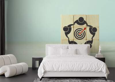 Common goal setting and success concept. Teamwork collaboration for achieving goal and successful business. Initiation for planning to reach target. Darts target aim, teamwork icon on wooden cubes. Wall mural