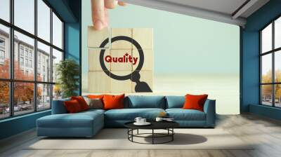 quality warranty concept. standardization, iso. hand placed wooden cubes with quality warranty icon  Wall mural