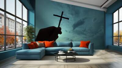 hand holding a cross, the background is the sun and clouds(dark tone).,Concept for Christian, god is the leader of life. Wall mural