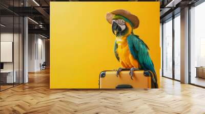 Parrot sitting on suitcase with sunglasses preparing for summer trip. Creative vacation concept. Wall mural