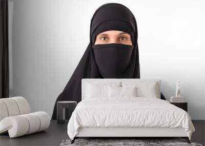 Portrait of a veiled islamic woman wearing black hiqab isolated on white background  Wall mural