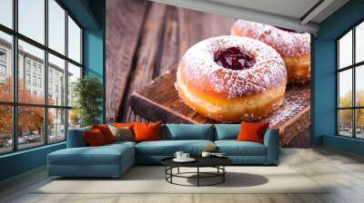 Traditional Polish donuts on wooden background. Tasty doughnuts with jam Wall mural