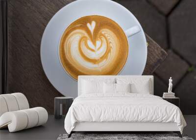 A white cup of coffee latte art on wood table Wall mural