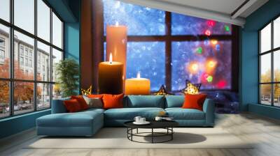 Winter decoration with candles near the snow-covered window Wall mural