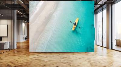 People paddling on surfboards in the blue sea during the day. Wall mural