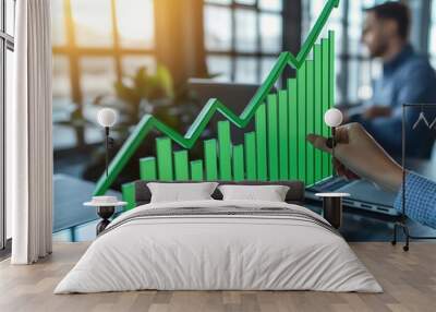 Businesswoman hand holding green bar graph of growth and curve up on glass table, depicting a business financial concept with a businessman working at the office using a laptop com Wall mural